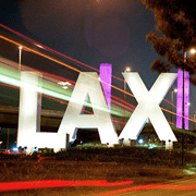 A large sign that says lax in front of the airport.